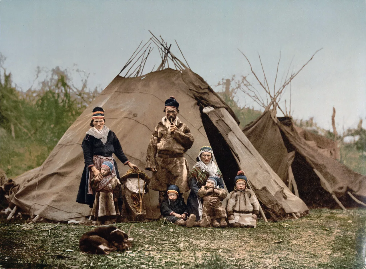 Sámi family in traditional clothing standing outside their lavvu tent dwelling in northern Scandinavia.